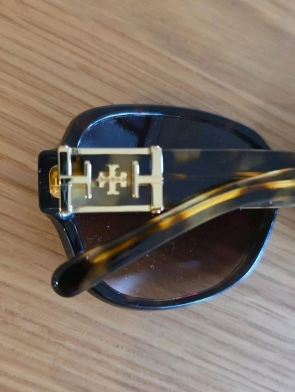 Tory Burch TY7073 sunglasses featuring a brown tortoise shell frame .